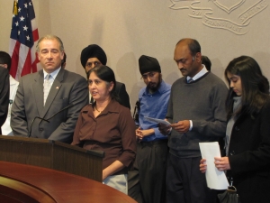Dolly Parikh speaks in favor of seatbelts in school buses accompanied by her husband, Pratik, right in grey sweater.