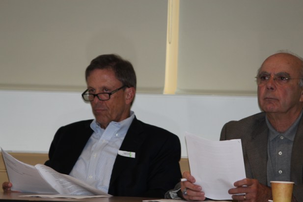 Finance Committee members leaf through a report outlining the system's fiscal challenges.