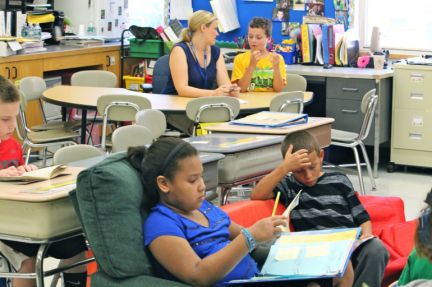 Marcy Deschaine, an elementary school teacher in Bristol, assesses a student.