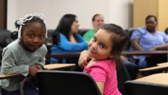 Tre'nia Younger, on the left, hangs out with her friend, Linda Carey, while their mothers talk with U.S. Rep. Jim Himes. 