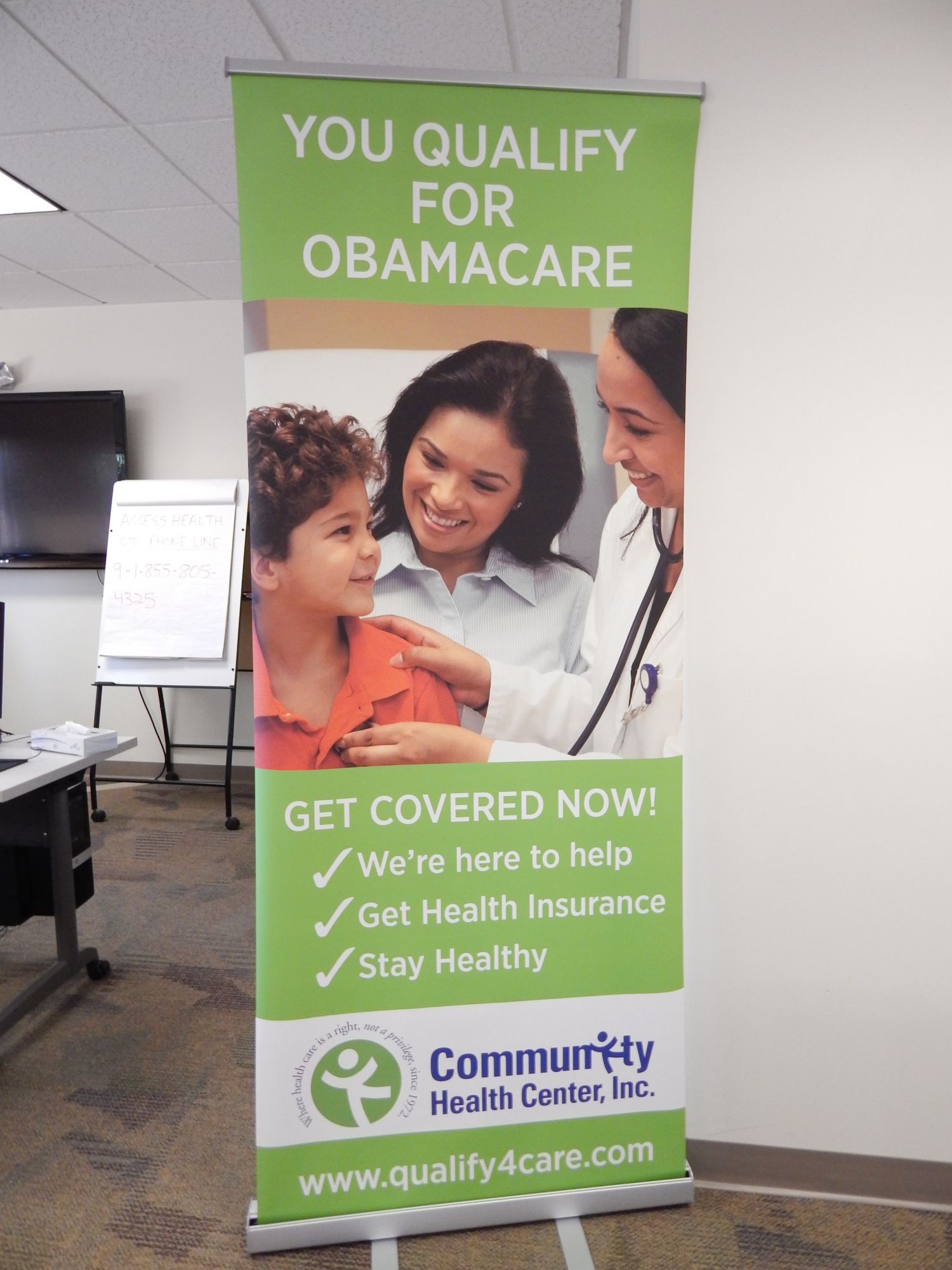 Photo of a sign that says "You qualify for Obamacare," at an enrollment fair at Community Health Center in New Britain.