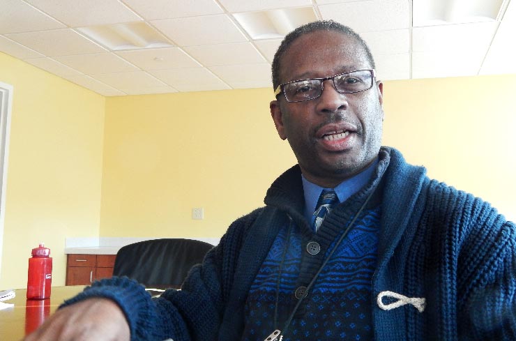 Jesse Grant, the outreach enrollment case manager at Hartford’s Charter Oak Health Center, says the people he talks to about health insurance come out happy. “I get hugs,” he said.  