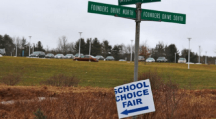 A sign directed Hartford-area parents to a school choice fair last weekend, where they could enter their child in the lottery to attend a magnet or suburban school.