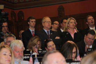 Danbury Mayor Mark Boughton, center, and his running mate, Heather Somers, listening to Malloy.
