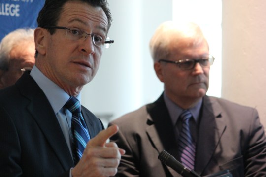 Gov. Malloy: "I am not talking about what happened in the past. I am talking about what needs to happen in the future." The system president stands behind him.