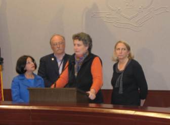 Sen. Beth Bye at lectern with, left to right, Sen. Toni Boucher, XX, and Rep. Roberta Willis