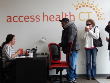 This is a photo of Pedro Lopez asking how long it will take to sign up for insurance at the Access Health CT store in New Britain.