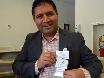 This is a picture of Dr. Setu Vora holding a list of strategies for anticipating and mitigating patient safety problems, which he keeps attached to his hospital badge.