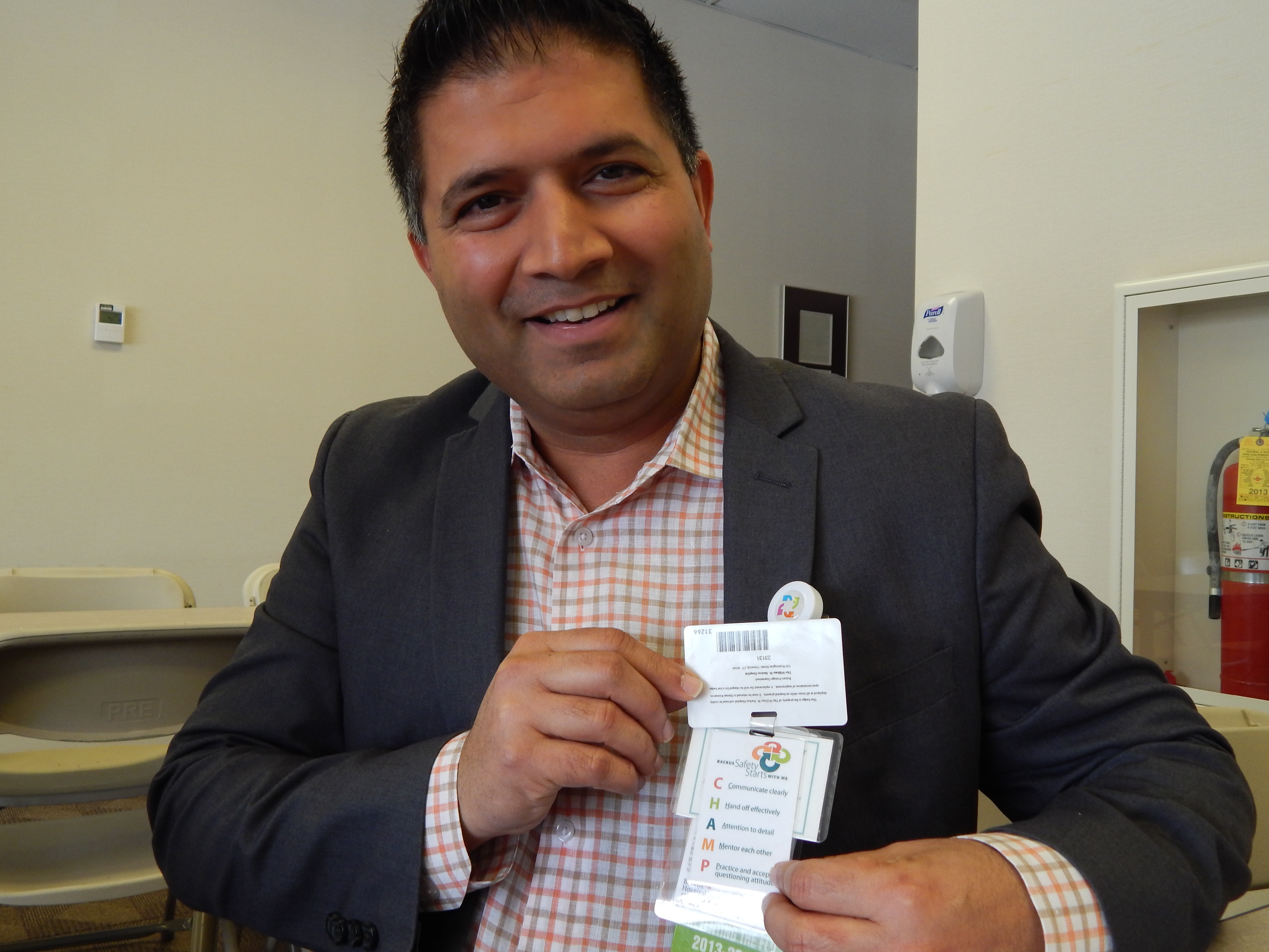This is a picture of Dr. Setu Vora holding a list of strategies for anticipating and mitigating patient safety problems, which he keeps attached to his hospital badge.