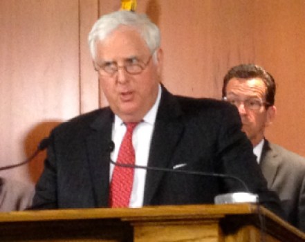 Arthur H. House, the chairman of PURA, with Gov. Dannel P. Malloy behind him.