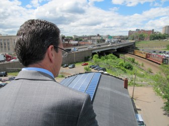 Gov. Dannel P. Malloy inspecting rooftop solar panels.