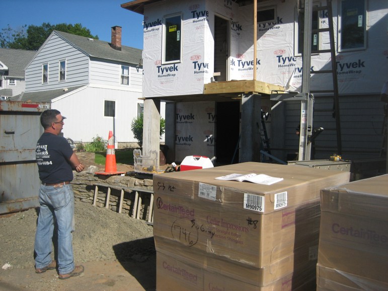 Contractor Dennis Pantani surveys Paula Brown's Branford home on Long Island Sound which flooded during storm Sandy. He is elevating it by eight feet, but very little is being done to protect it from wind damage.