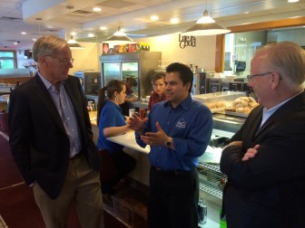 Tom Foley listens to Elmer Palma. At right, Mayor Mark Boughton.