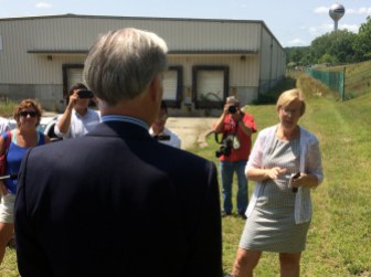 Foley and Osten faced each other outside a factory.
