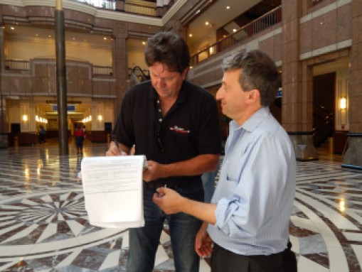 Joe Visconti signs Jonathan Pelto's petition for a spot on the November ballot for governor. Pelto later signed Visconti's petition.