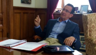 Dan Malloy at his desk july 2014