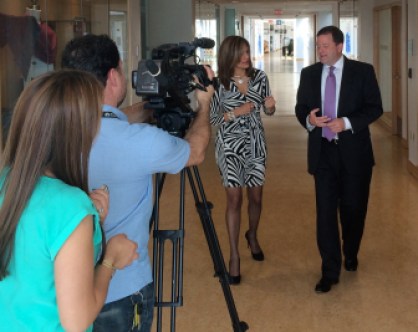 John P. McKinney talking to a Univision reporter at Hartford Public Library.