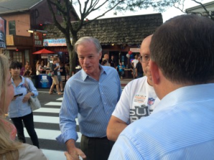 Tom Foley greets two voters: John P. McKinney and McKinney's fiancee, Kristin Fox.