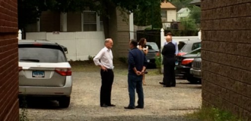 Tom Foley confers with his campaign manager, Justin Clark, outside their headquarters in Southington.