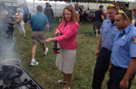 Rep. Elizabeth Esty gets a hands-on lesson from fire fighters at the Terryville Fair.