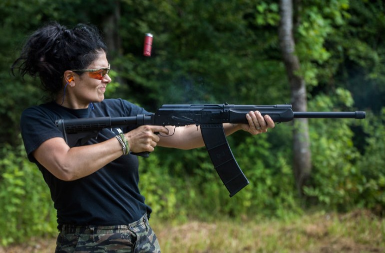Kimberly Jones, a member of the Citizens Militia of Mississippi  fires a semi-automatic tactical shotgun.