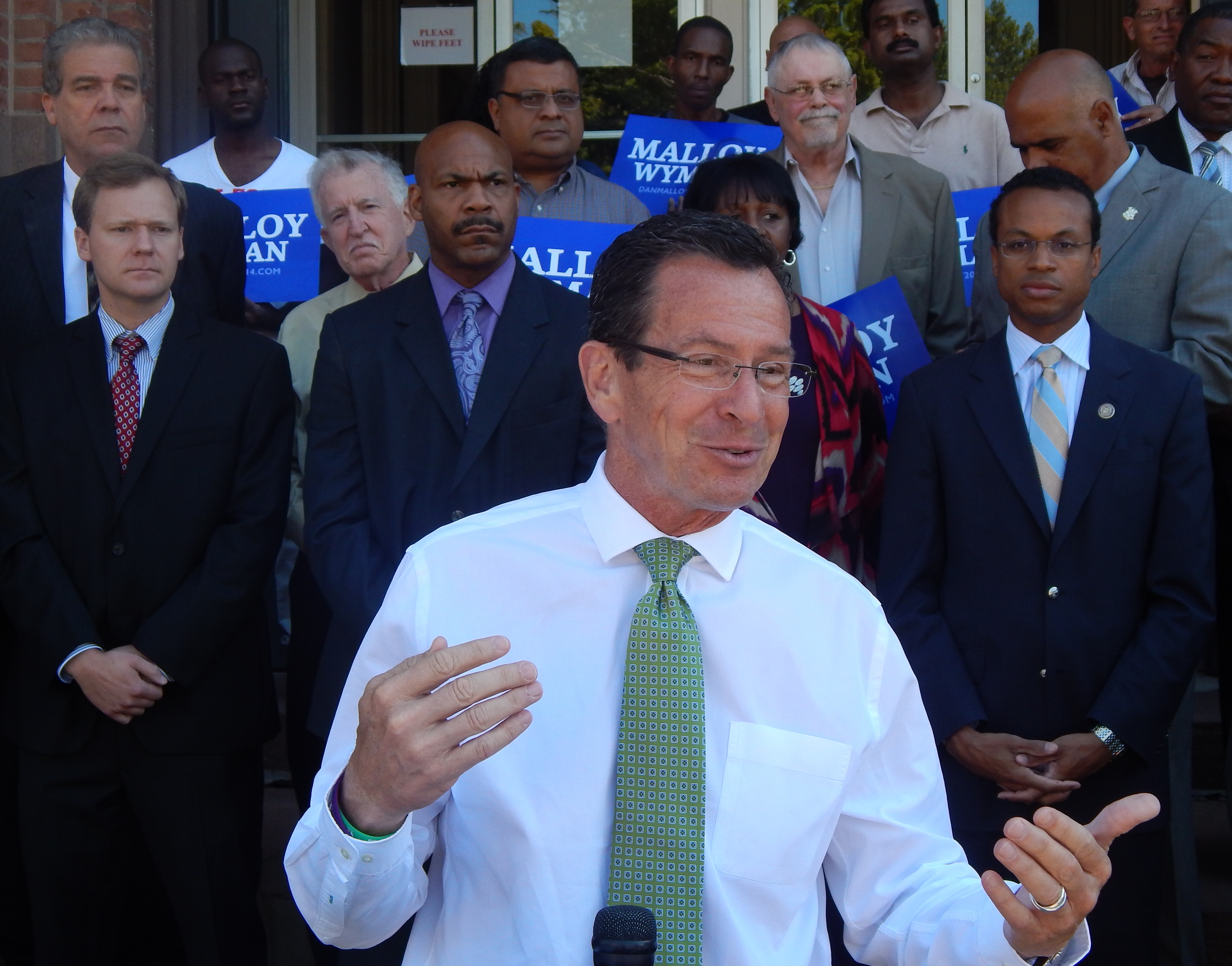 Gov. Dannel P. Malloy unveils his proposal for urban small business tax incentives outside Faith Congregational Church in Hartford during the 2014 campaign.