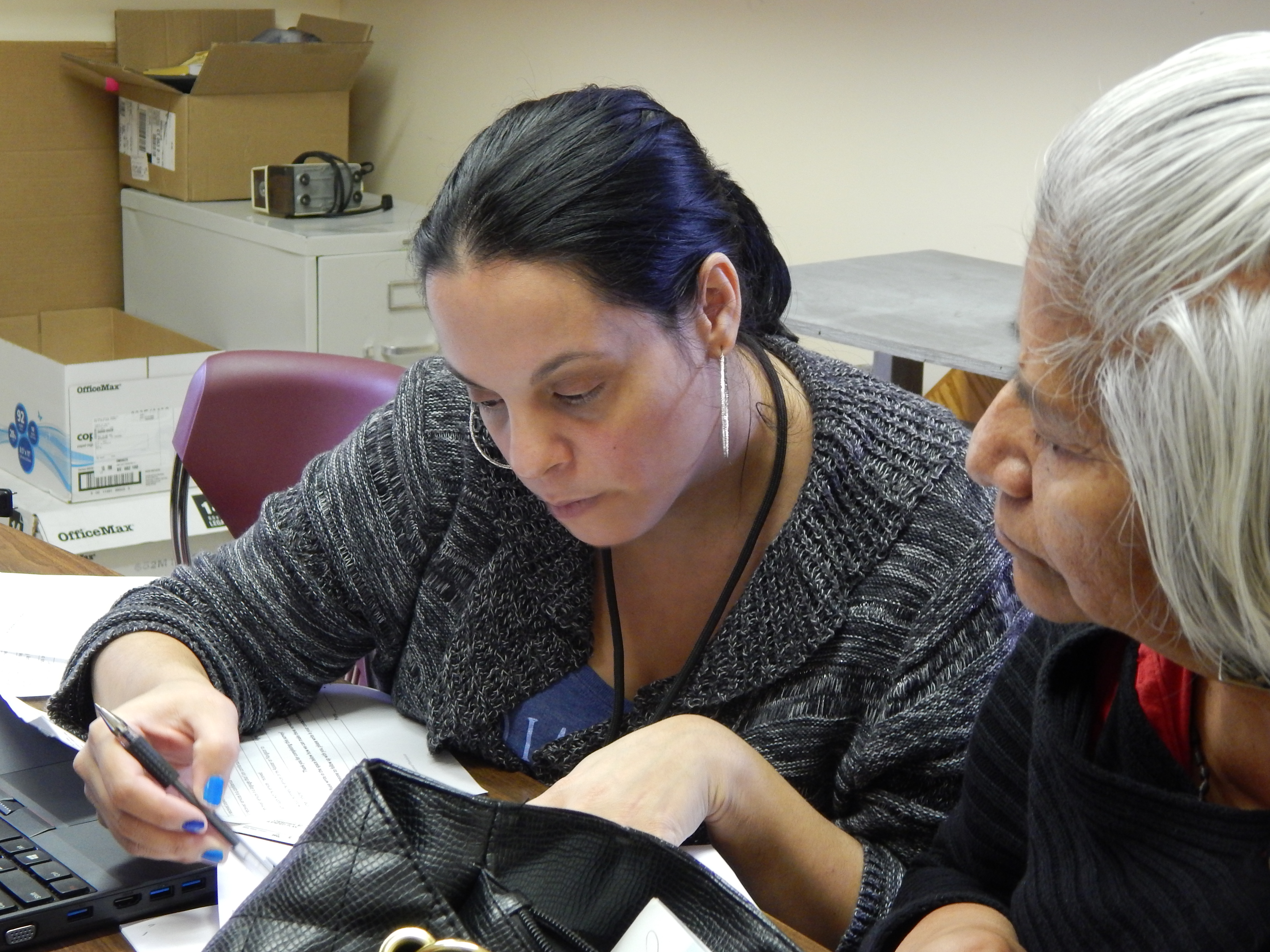 Jessie Rivera, an in-person assister, helped a woman sign up for coverage at an enrollment fair in Windham last December.
