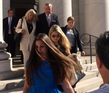 John G. Rowland exits court with his wife, Patricia, preceded by his daughters.