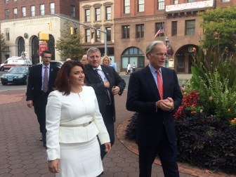 Tom Foley walks from New Britain city hall with Mayor Erin Stewart, trailed by other mayors.