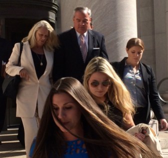 John G. Rowland and wife, Patty, led by his two daughters as the trial opened.