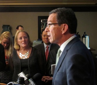 As his wife, Cathy, listens, Malloy says, "I never drove my wife off a road."