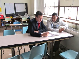 Gov. Malloy works with a student in a school in Norwalk earlier this year