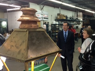 Gov. Dannel P. Malloy touring Penn Globe, a lighting company that added three jobs.