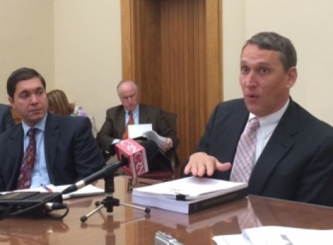 State budget director Benjamin Barnes talks with reporters Monday.