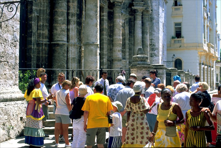 Foreign tourists enjoy the colonial architecture of Old Havana.