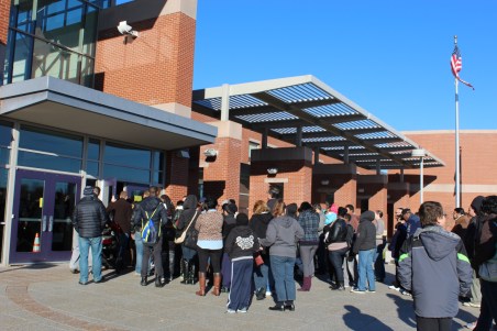 Parents wait with their children for a school choice fair to start in Southwest Hartford last year