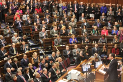 Malloy at the podium in the House chamber at the Capitol.
