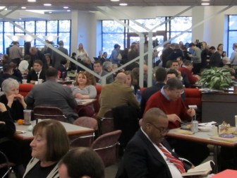 Other diners quickly ignored the media huddle around Malloy's table, which is visible in the mirror on the rear wall.