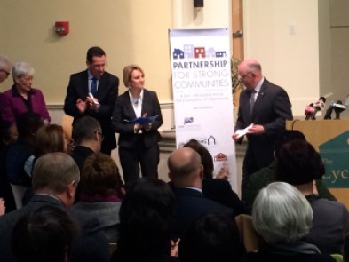 Gov. Dannel P. Malloy and Housing Commissioner Evonne Klein applauds his commissioner of veterans' affairs, Joe Perkins.