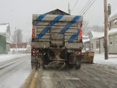 A plow and materials spreader at work.