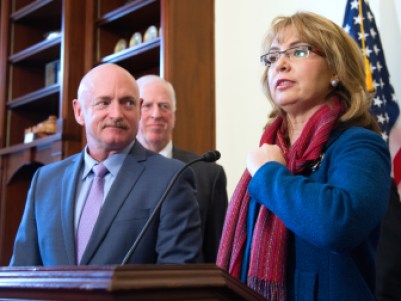 Former U.S. Rep. Gabrielle Giffords of Arizona and her husband, former astronaut Mark Kelly, at a press conference Wednesday marking re-introduction of a bill calling for expanded background checks for gun buyers.