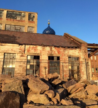 The blue onion dome of the Colt East Armory is seen behind a building in the complex that may be turned over to the National Park Service.
