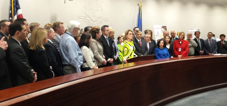 Republican legislators gather around their leadership as the GOP presented its alternative budget proposals Friday.