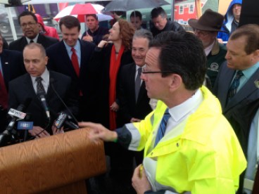 Gov. Dannel P. Malloy needed a raincoat at DOT news conference last year. He may be facing another rainy day.