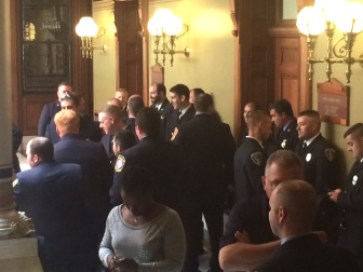 Firefighters crowd the halls outside the Senate on Thursday.