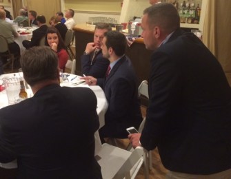 J.R. Romano, seated at right, tracks balloting. At left are Mayor Erin Stewart of New Britain and her chief of staff, John J. Healey.