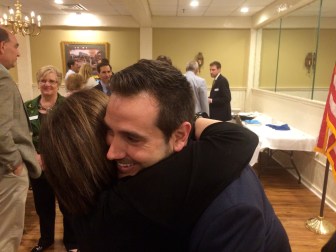 J.R. Romano is congratulated by Ruby O'Neill, wife of Rep. Art O'Neill.