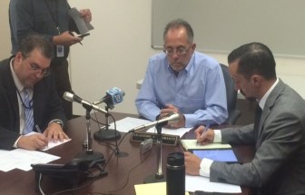 Commissioner Sal Bramante, flanked by General Counsel Michael Brandi, left, and Kevin Ahern.