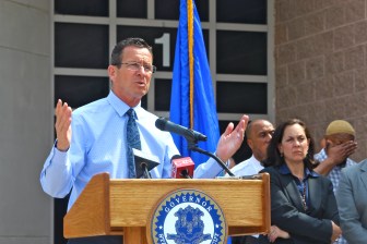 Gov. Dannel P. Malloy outside the entrance of the Connecticut Juvenile Training School in Middletown, a locked jail for young males that break the law. Joette Katz, his commissioner for the Department of Children and Families that runs the facility, watches.