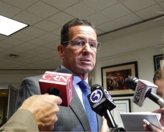 Gov. Dannel P. Malloy speaks to reporters after addressing housing advocates at the Hartford offices of the Community Renewal Team Wednesday.
